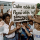 Holders of the alleged winning Pepsi-Cola bottle crowns protest outside the American company's main office at Manila in 1992, demanding their million peso prize. A riot erupted when the wrong number, 349, was announced on television and later withdrawn.